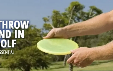 A disc golfer learning how to throw a backhand shot in disc golf.