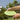 A disc golfer learning how to throw a backhand shot in disc golf.